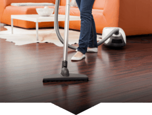 woman with vacuum cleaner cleaning the floor